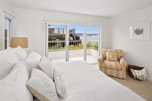A bedroom with a large bed, a sofa, and a balcony with a view of the sea. - Bay Front Luxury Penthouse w/elev. & AC! Enjoy multiple outside patios & views! (San Diego)