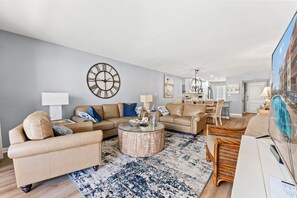 A living room with a sofa, coffee table, and dining area. - Anchorage II 205  Lovely 2 Bedroom Condo With Great Ocean Views and Outdoor Swimming Pool (MYRTLE BEACH)