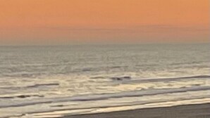 A beach scene with a clear sky and ocean waves. - Beachfront Home! Ready for the summer! (Galveston)