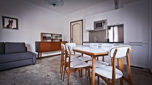 A modern kitchen with white cabinets, a built-in microwave, and a stainless steel refrigerator. - VICTORY HOUSE 4 FRONT LAKE AP3 GARDEN & SPA (Colmegna)