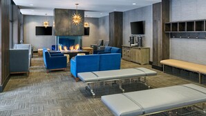 A modern lounge area with a fireplace, seating, and a television. - Inviting, cabin like condo, close to Gore Creek w/ access to all Grand Hyatt Amenities (Vail)
