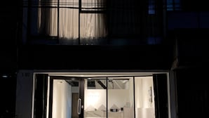A hotel entrance with a glass door, a reception desk, and a seating area visible inside. - Stay Inn Hostel Jakarta - Adults only (Jakarta)