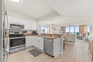 A modern kitchen with stainless steel appliances, a dishwasher, and a granite countertop.