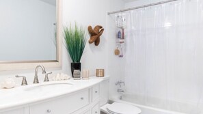 Combined shower/bathtub, hair dryer, towels, toilet paper