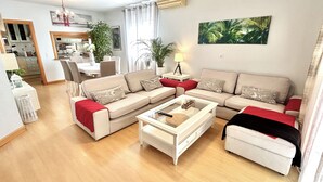 A living room with a sofa set, a coffee table, and a dining area with chairs. - Villa with private pool, large garden and leisure activities, 20 min from Madrid (Navalcarnero)