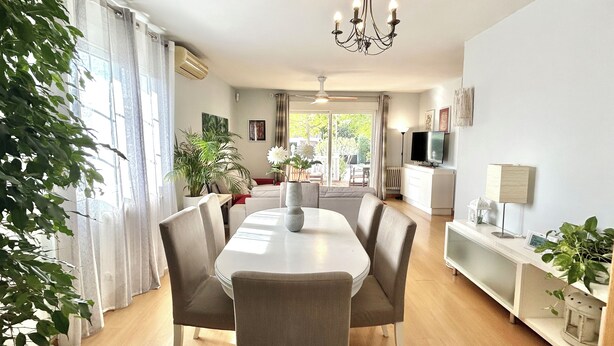 A dining area with a table, chairs, a chandelier, and a TV. - Villa with private pool, large garden and leisure activities, 20 min from Madrid (Navalcarnero)
