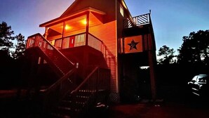 A wooden building with a balcony and a star symbol on the side.
