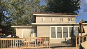 A two-story house with a deck, a covered patio, and a garage. - Lakefront home on Little Barbee that sleeps 6 (Warsaw)