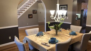 A dining area with a table set for four, surrounded by chairs, a chandelier, and framed pictures on the walls. - H-DERBY, Keeneland, Bourbon or Family Gathering!  (Frankfort)