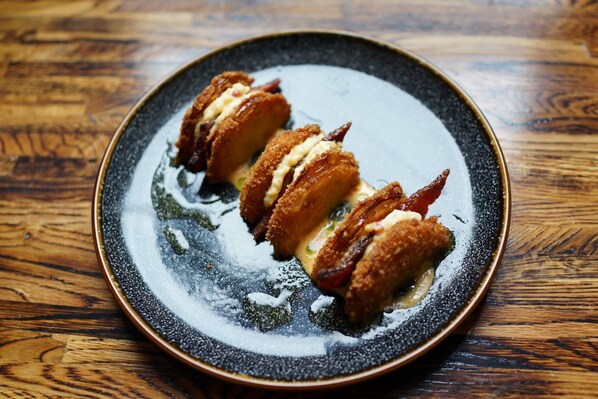A plate with a dessert on a dark ceramic plate.