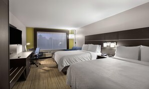 A hotel room with two beds, a desk, a chair, a TV, and a window with a view. - Holiday Inn Express Lake Park by IHG (Lake Park)