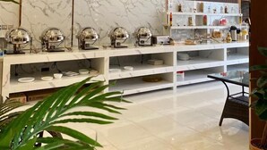 A modern kitchen with marble countertops, stainless steel appliances, and a variety of kitchenware. - Aral Hotel (Tabuk)