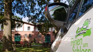 A car with a side mirror and a logo that reads 'Feren am Schloss.'