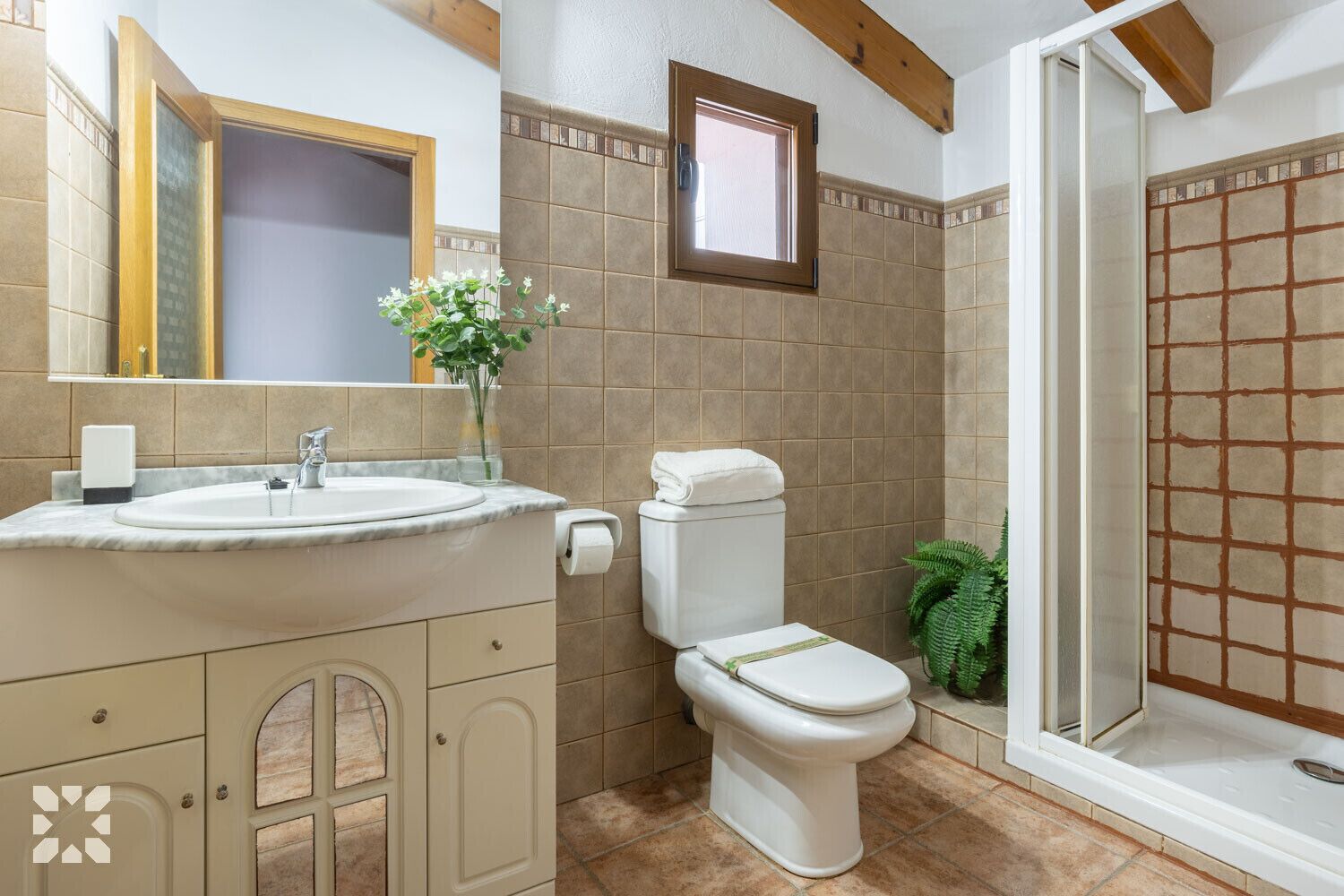 A bathroom with a sink, toilet, and shower.