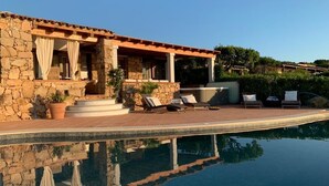 A stone building with a pool, outdoor seating, and a pergola. - Villa Caterina, amazing front sea 2 Br villa with private beach (Punta Molara)