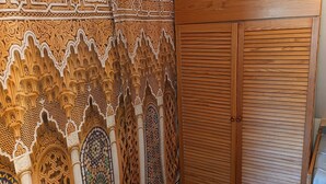 A room with intricate wooden paneling and a large wooden wardrobe. - Apartment Noerdliches Muensterland (Hopsten)