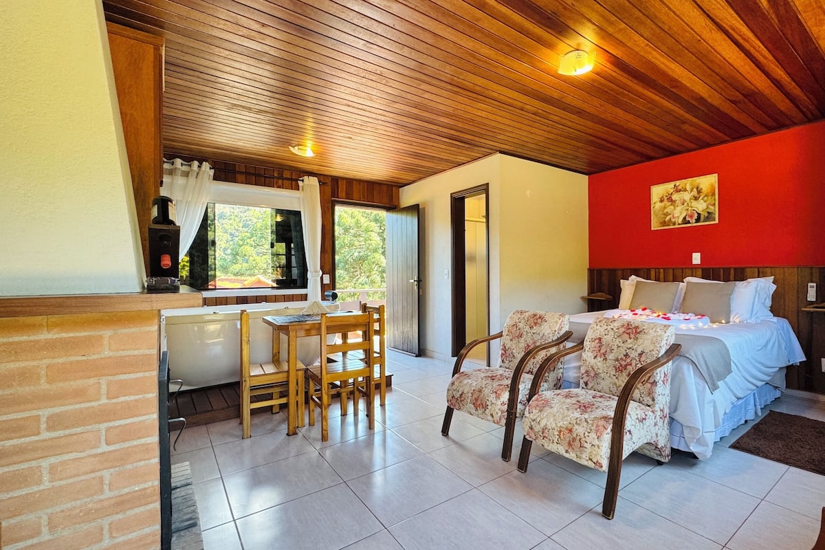 A room with a bed, a desk, and chairs.
