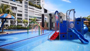 A swimming pool with a water slide and a children's play area. - Hotel Pen Mutiara (George Town)