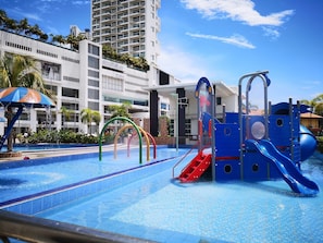 A swimming pool with a water slide and a children's play area. - Hotel Pen Mutiara (George Town)