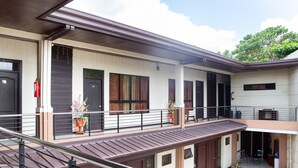 A multi-level building with balconies, railings, and outdoor seating areas. - OYO 153 Espacio de Clarita Hometel (Davao)