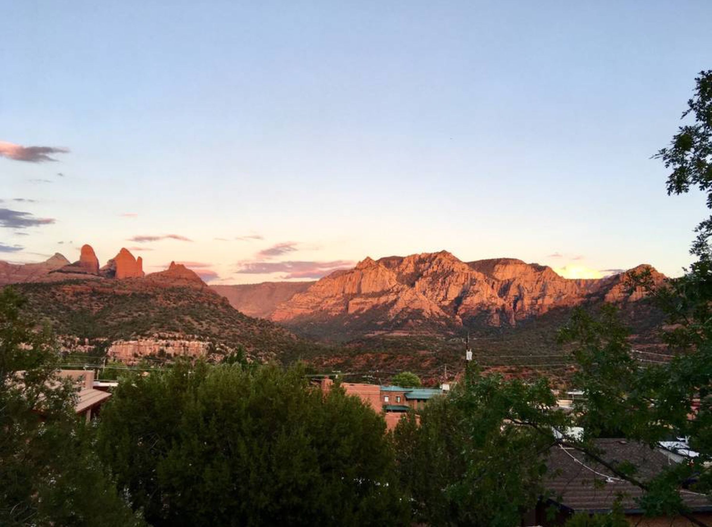 A mountainous landscape with a valley and a small settlement.