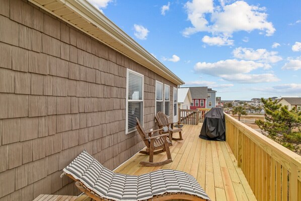 A wooden deck with lounge chairs and a barbecue grill. - Modern Pet Friendly Home ~Ocean & ICW Views w/elevator (Surf City)