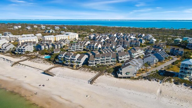 An aerial view of a coastal residential area with beachfront properties, a beach, and a clear view of the ocean. - Dog-Friendly·Gulf Views· Steps to White Sand Beach (Port Saint Joe)