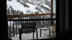 A balcony with a view of a snowy mountain landscape.