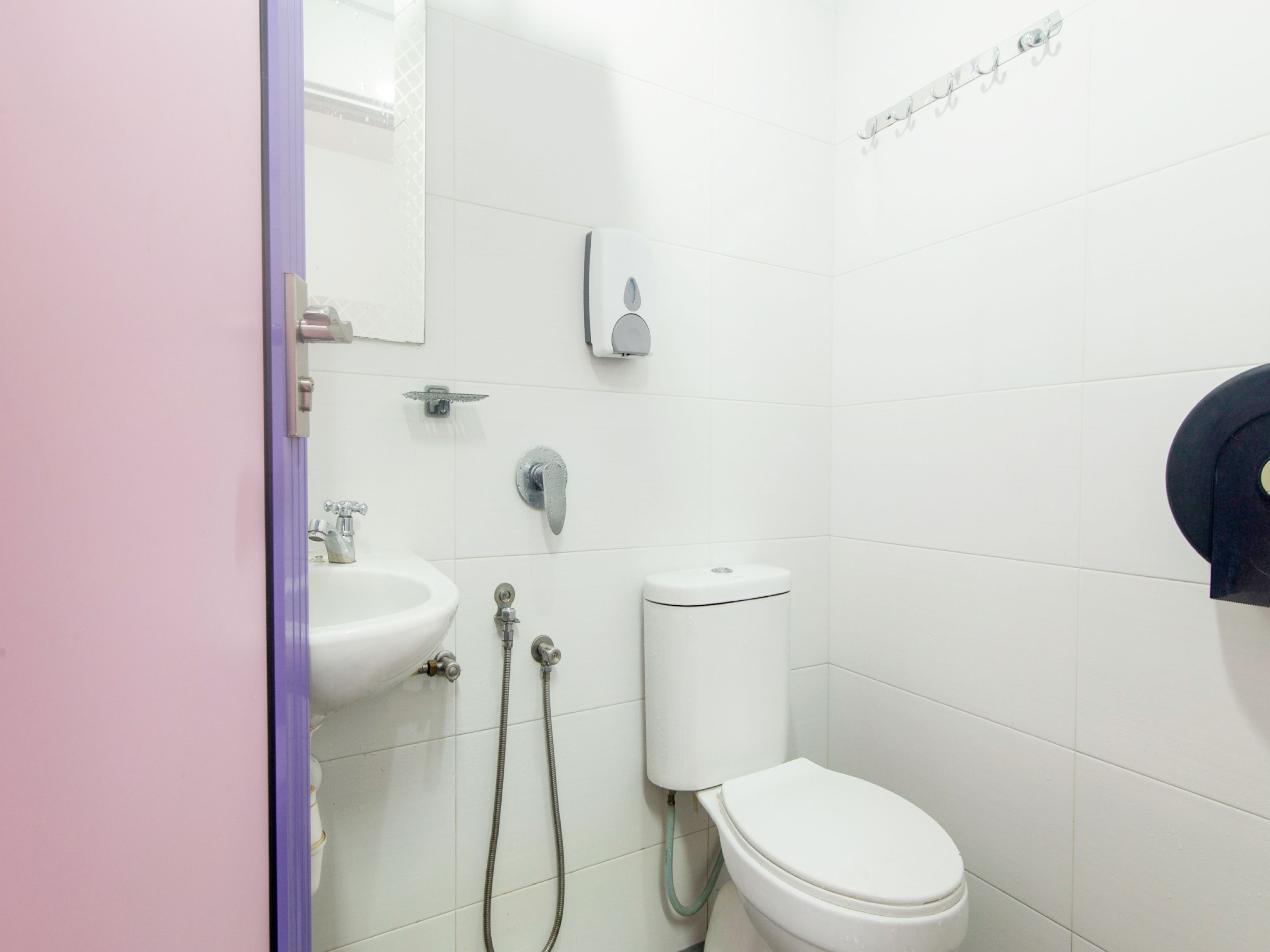 A bathroom with a sink, toilet, and shower.