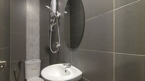 A modern bathroom with a toilet, sink, and shower. - OYO 876 Hotel Sanctuary (Petaling Jaya)