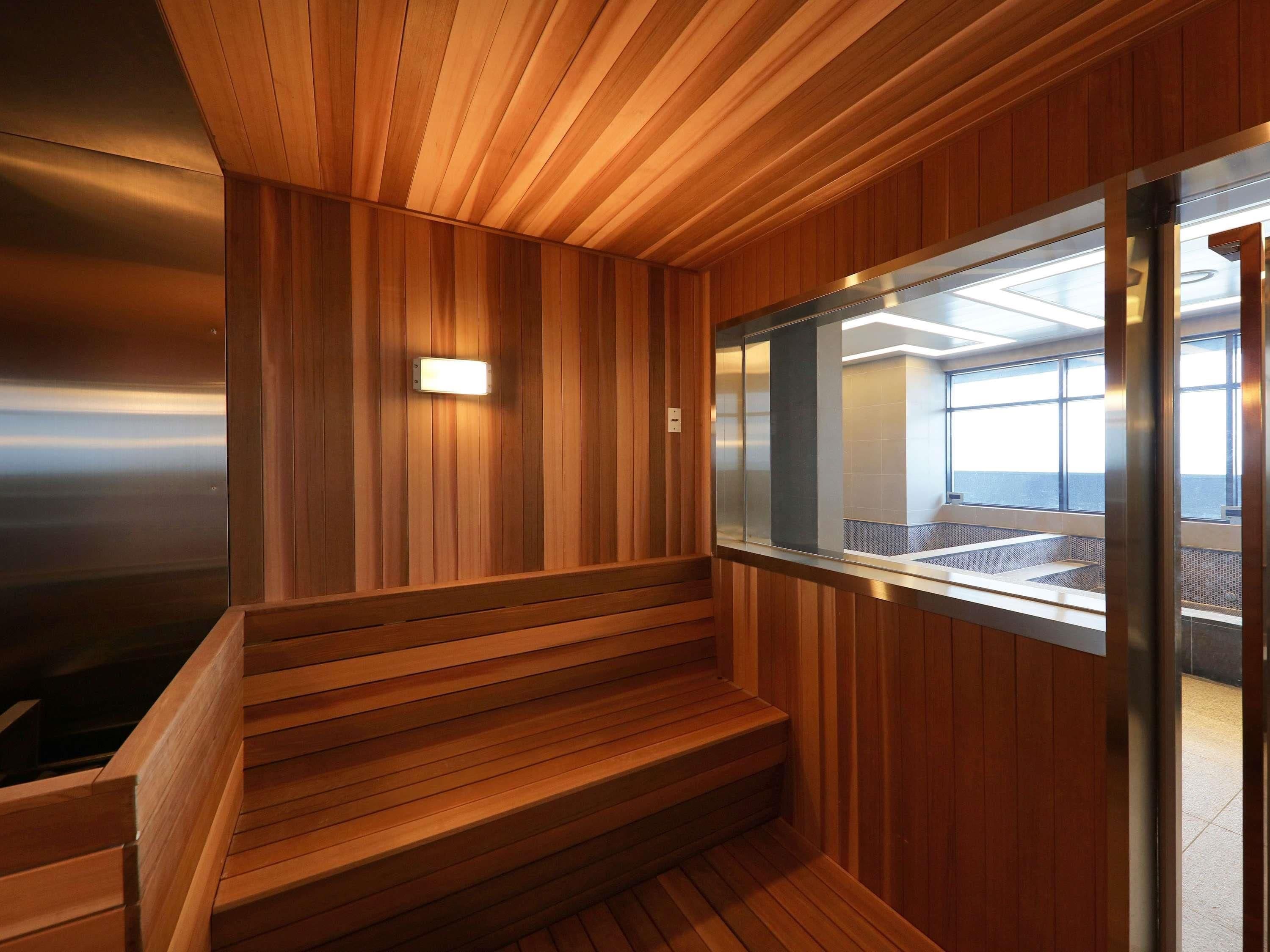 A wooden staircase with a glass partition leading to a room with a view.