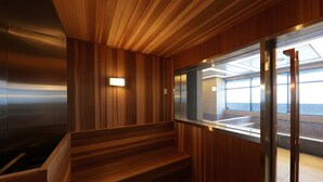 A wooden interior with a staircase, a glass elevator, and a view of the outside. - Mercure Ambassador Ulsan (Ulsan)