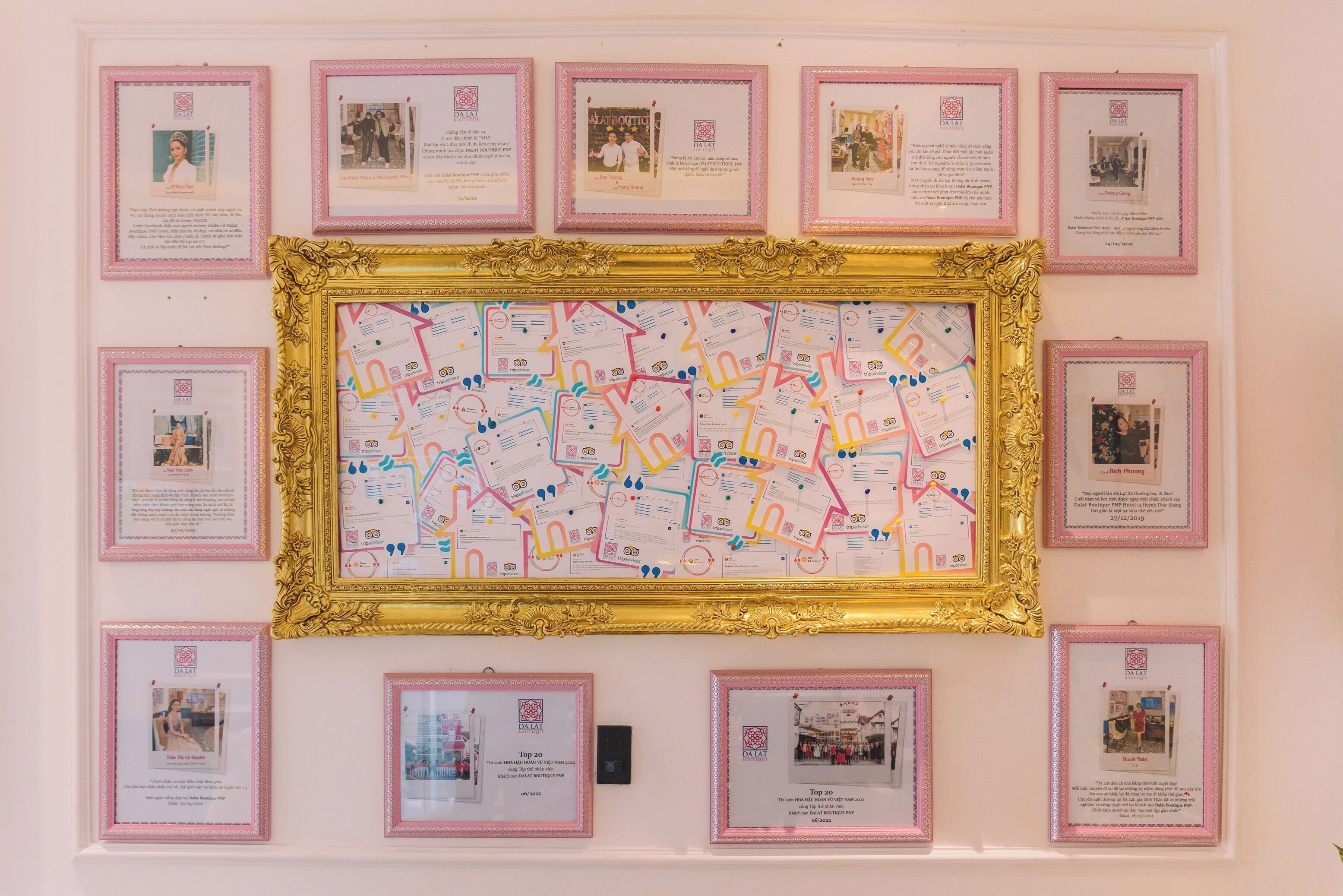 A wall with framed certificates and a large map.