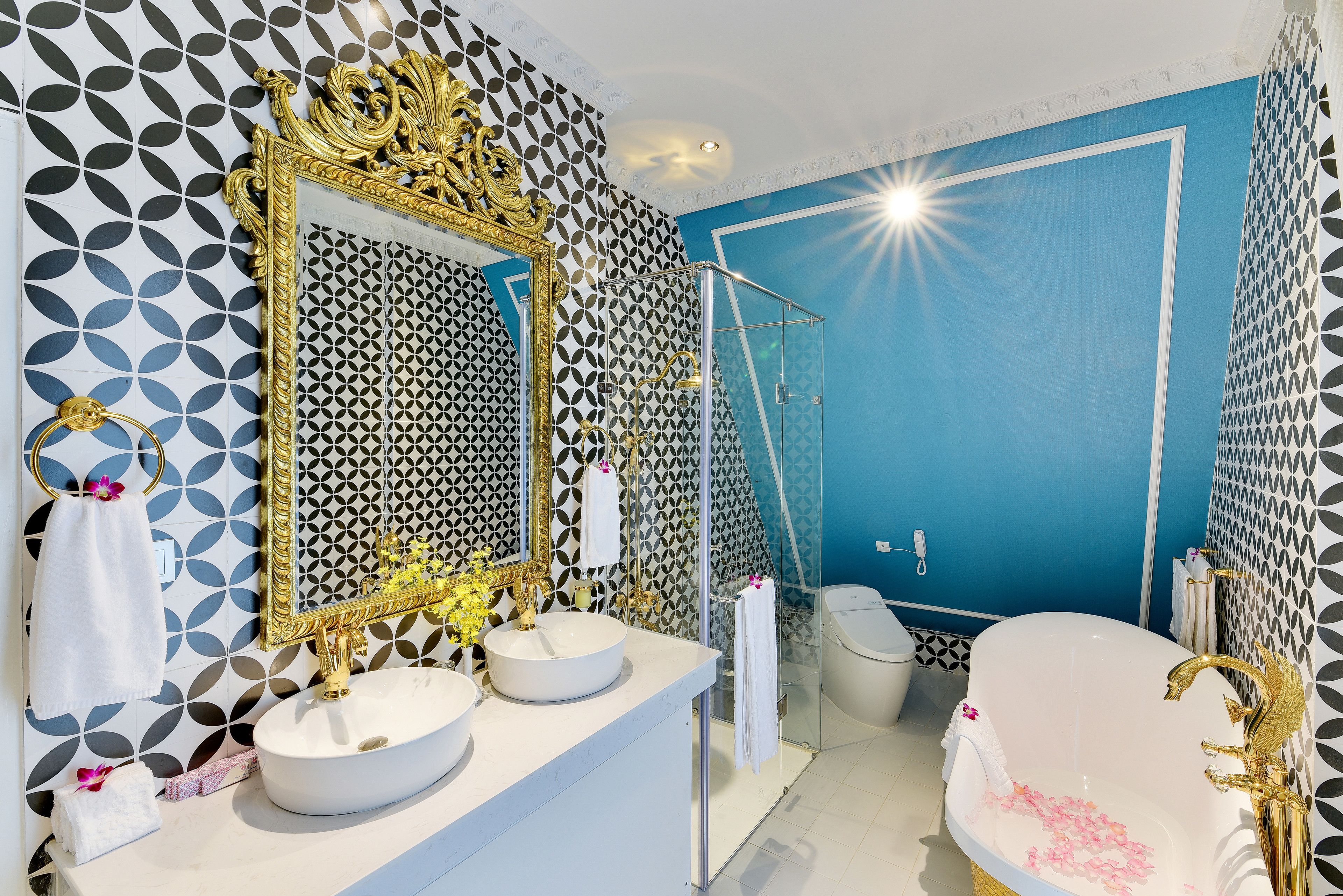 A bathroom with a large mirror, two sinks, a bathtub, and a shower.