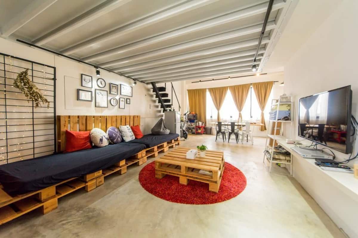 A modern living room with a sofa, coffee table, and TV.