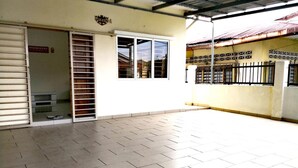 A building with a tiled floor, a sliding door, and a window.