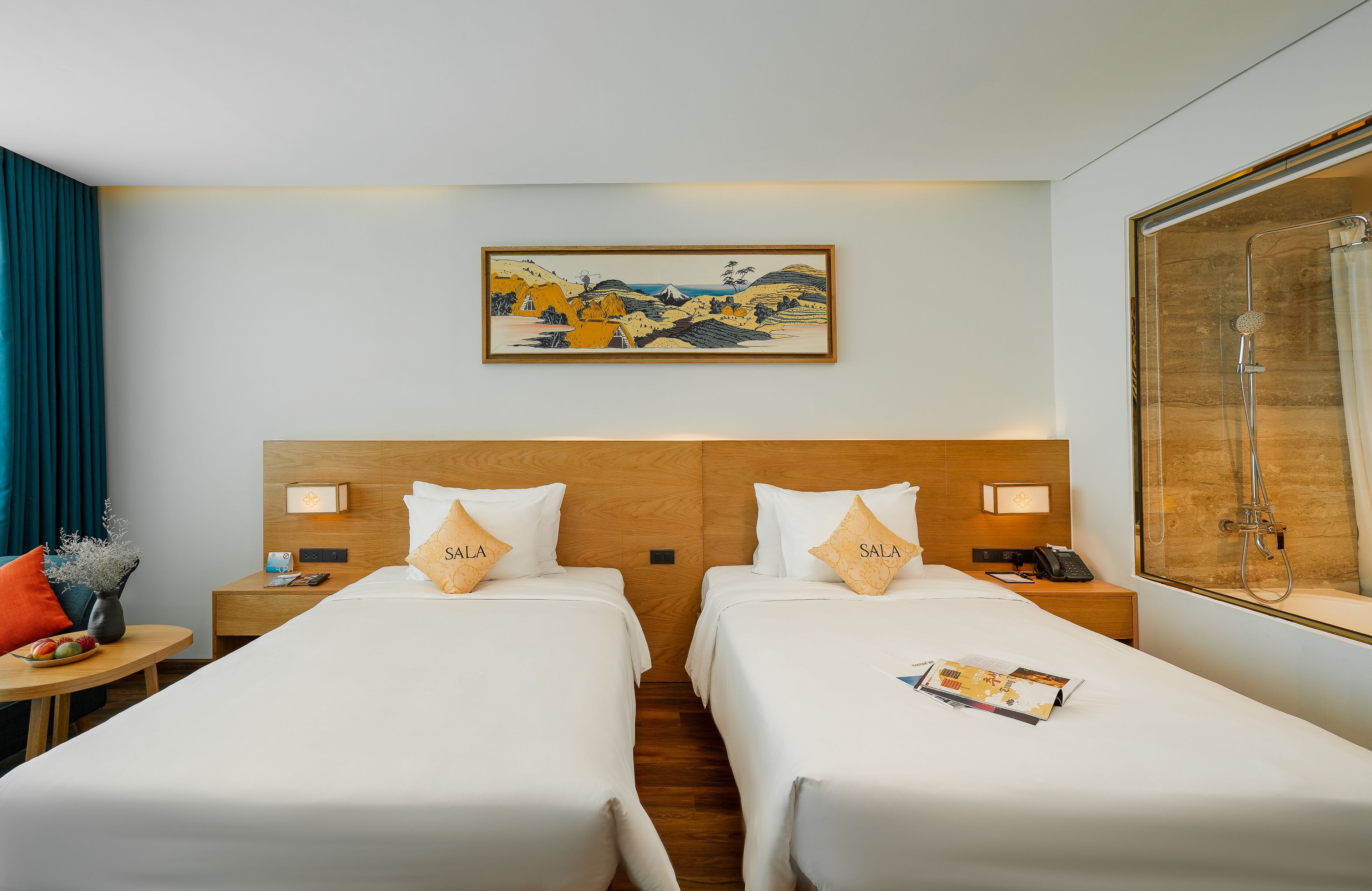 A hotel room with two beds, a painting on the wall, a shower, and a nightstand with a phone.