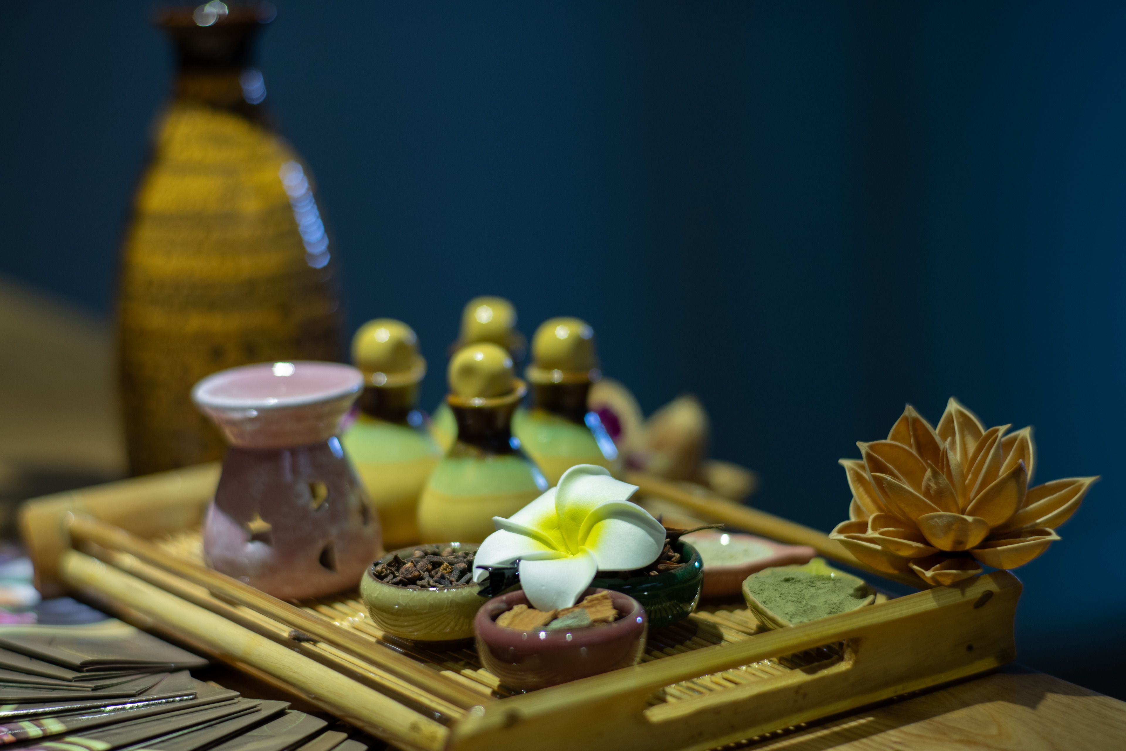 A tray with various small bowls containing different items, likely for a spa or wellness setting.