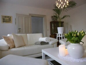 Deluxe Apartment, Garden View | Living room | Flat-screen TV