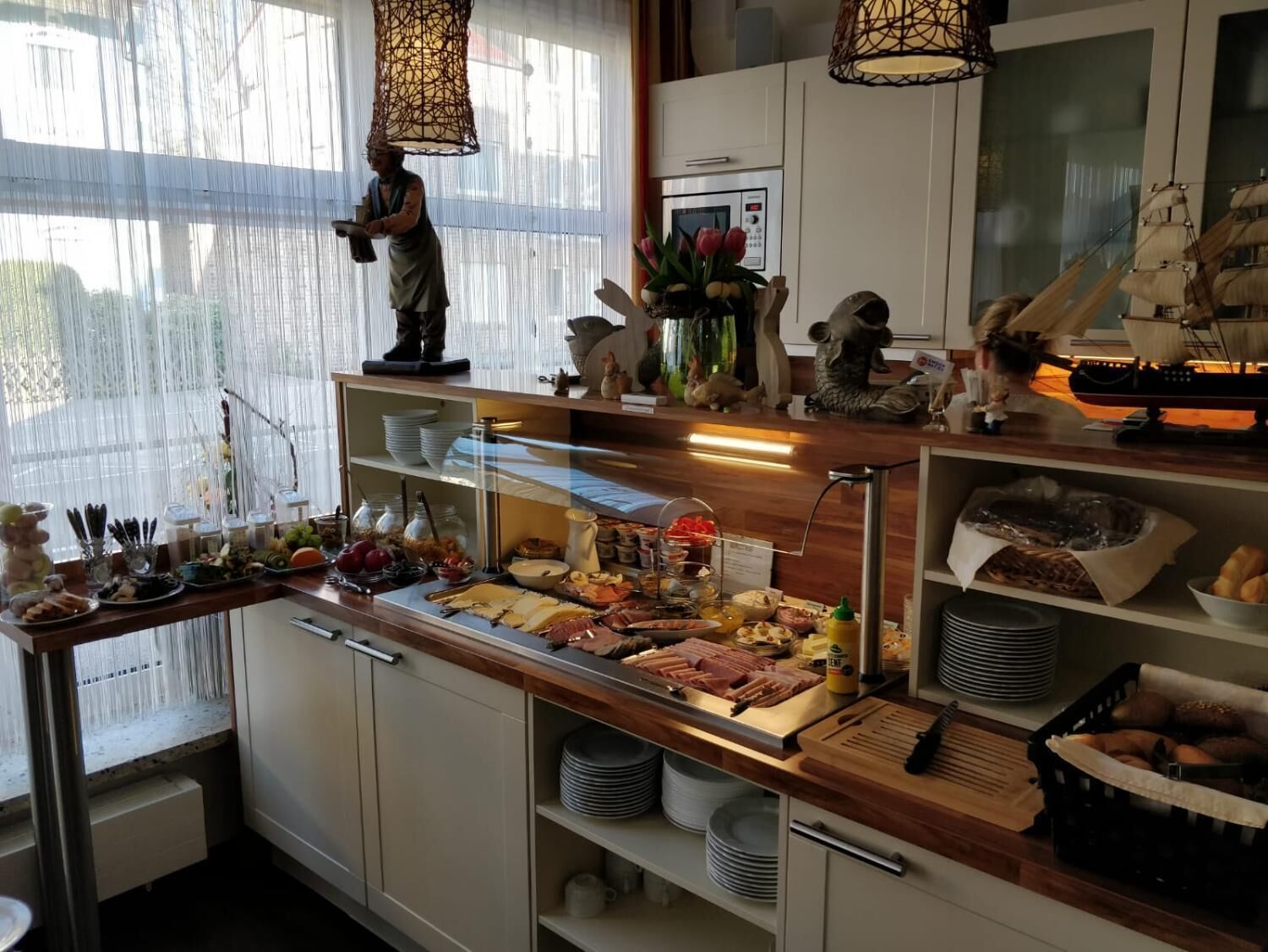 A buffet setup with various food items and utensils.