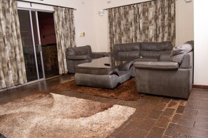 Family House | Living area | 50-inch flat-screen TV with satellite channels, TV - Tamarind Holiday and conference Resort  (Kariba)