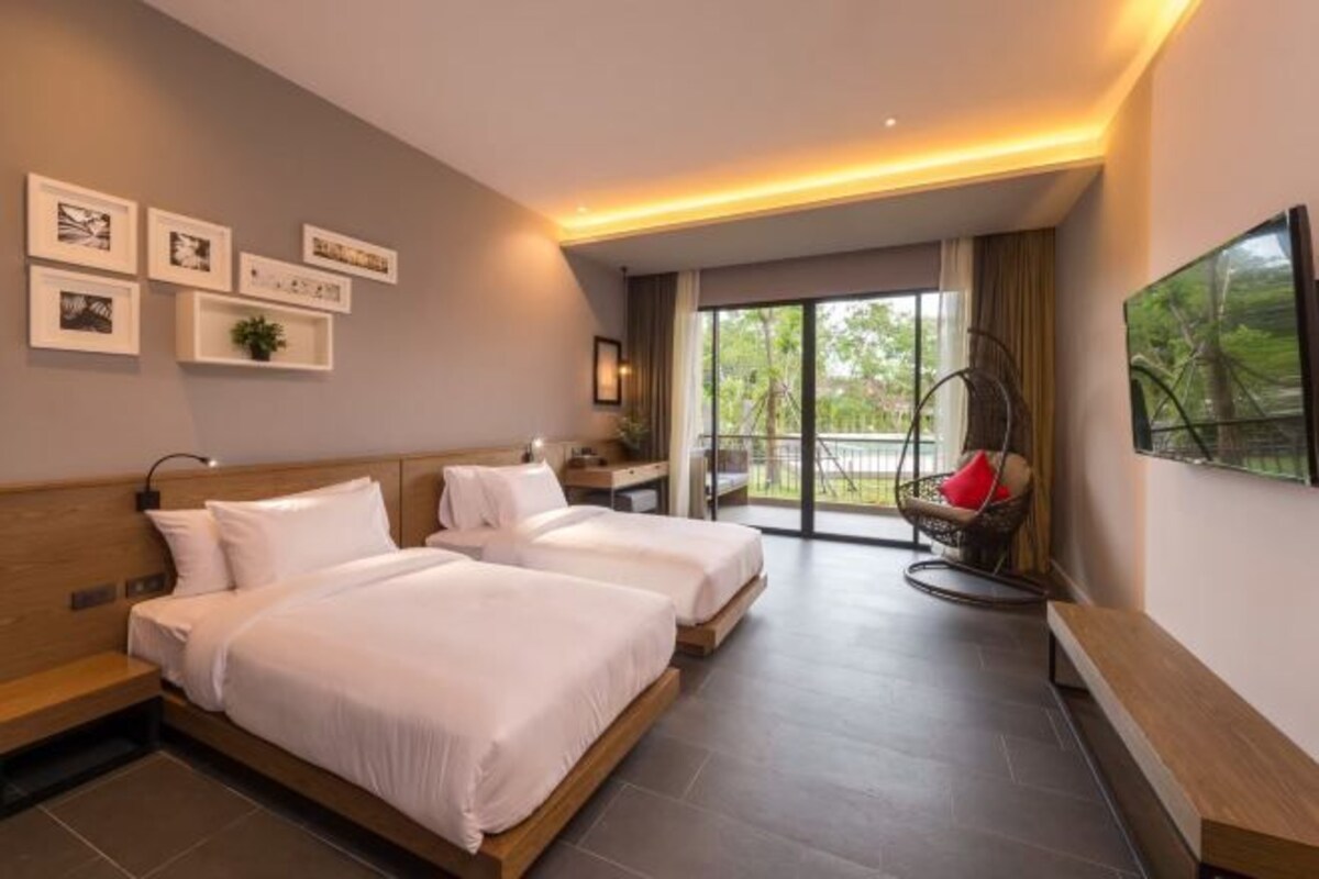 A modern hotel room with two beds, a large window, and a balcony.
