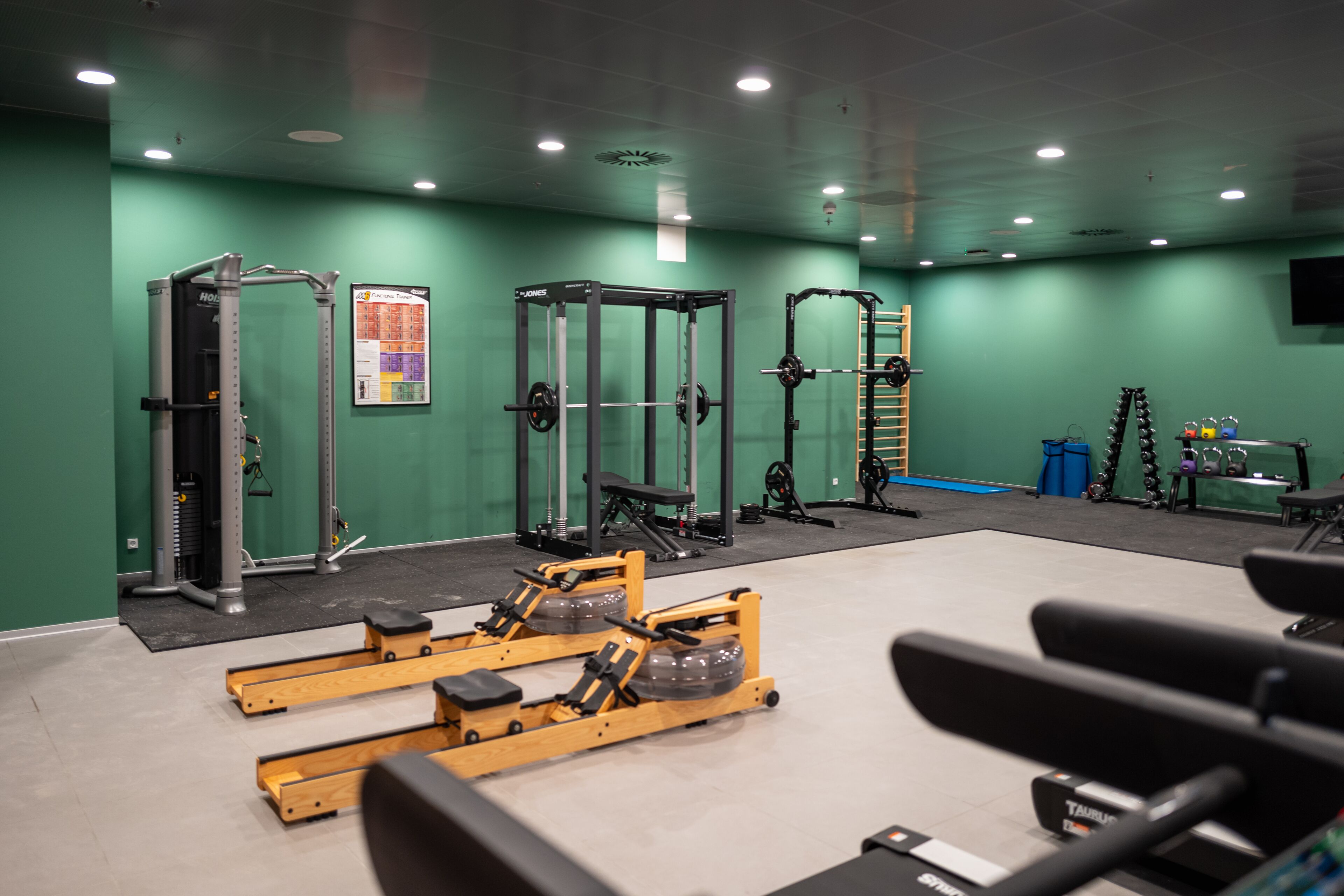 A gym with various exercise equipment, including weight machines and free weights.