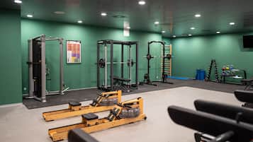 A gym with various exercise equipment, including weight machines and free weights.
