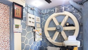 A reception desk with a clock, a calendar, and a sign indicating check-out time. - Hexa Metro Plaza (Mumbai)