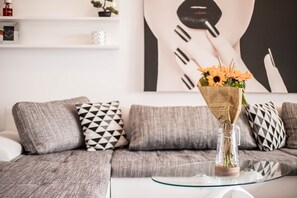 Relax in this stylish living room with a sofa, coffee table, and vibrant artwork.