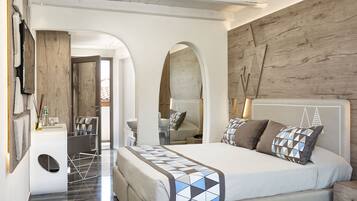 A modern bedroom with a large bed, a wooden headboard, and a built-in desk with a chair.