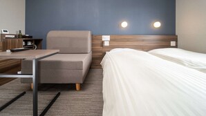 A hotel room with a bed, a sofa, a desk with a computer, and a nightstand. - Super Hotel Yamaguchi Yuda Onsen (Yamaguchi)