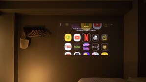A hotel room with a bed, a desk, and a wall-mounted TV displaying various streaming service icons. - Super Hotel Yamaguchi Yuda Onsen (Yamaguchi)
