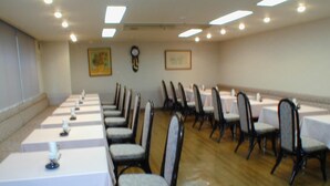 A conference room with long tables, chairs, and ceiling lights. - Hotel Satoh Tokyo (Tokyo)